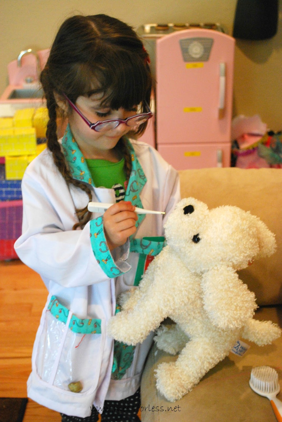 girl playing with toy dog in dramatic play vet center