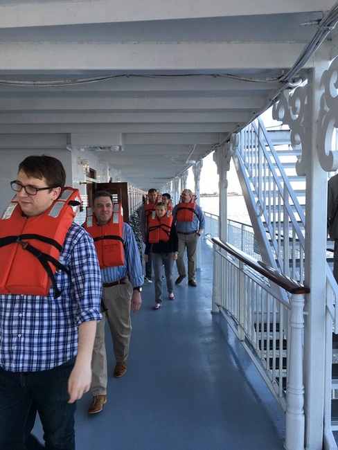 Passengers on a river boat participate in a safety and muster drill upon embarkation.