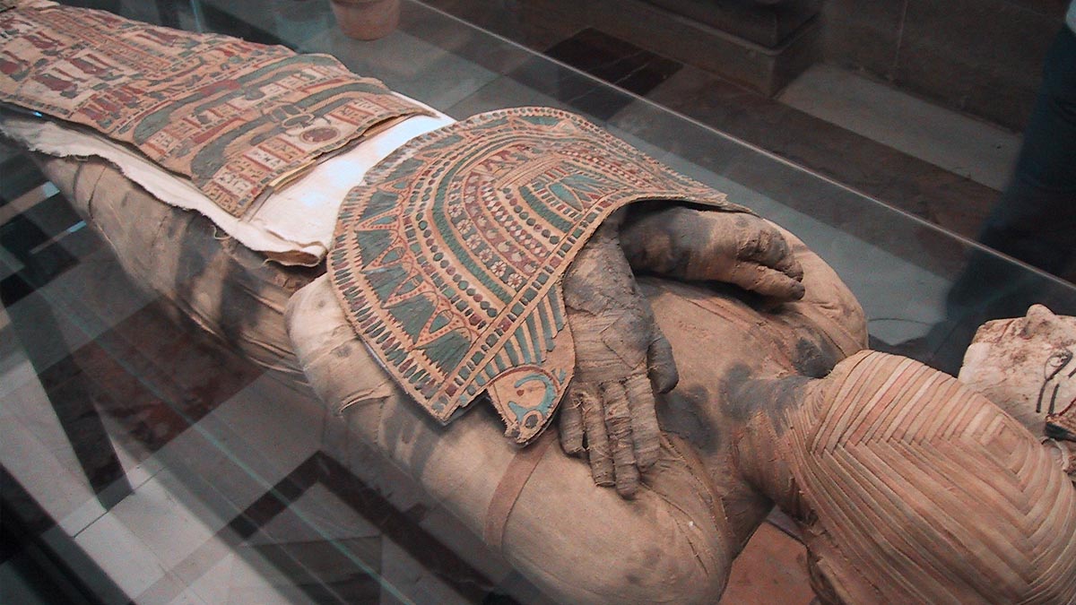 Photo of an Egyptian mummy covered in wrappings and decorations.