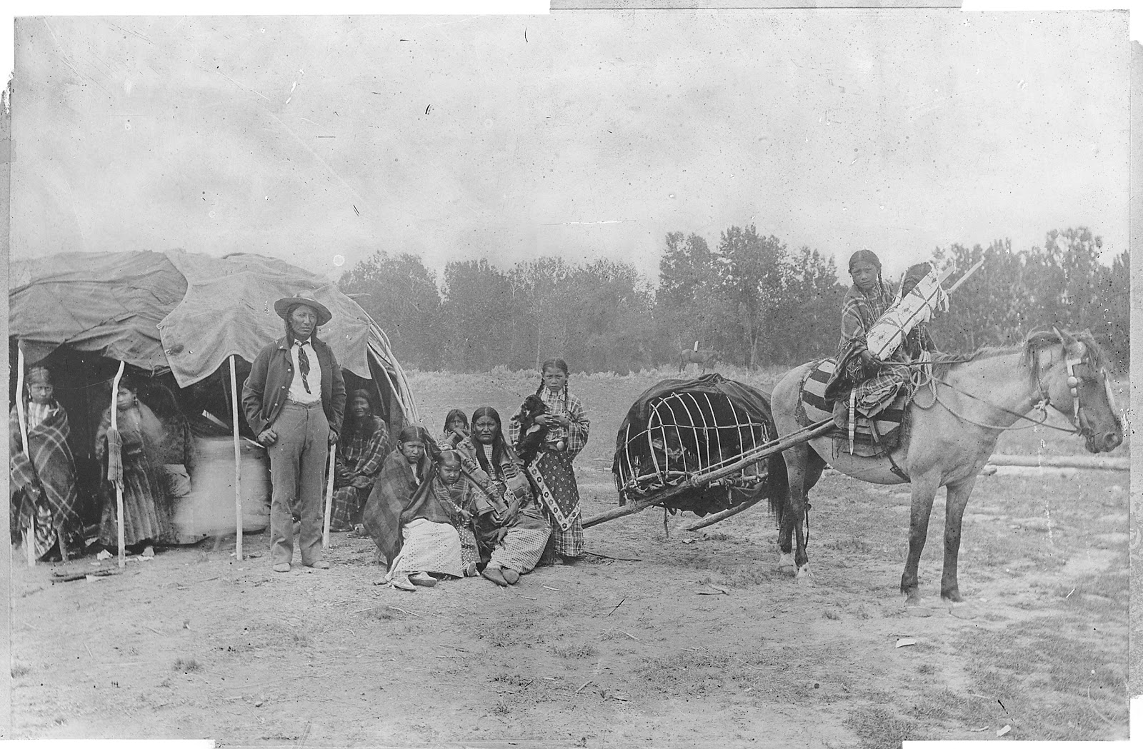 “Cheyenne: Stump Horn and family showing Horse Travois.” Author unknown (U.S. National Archives and Records Administration) [Public domain], via Wikimedia Commons