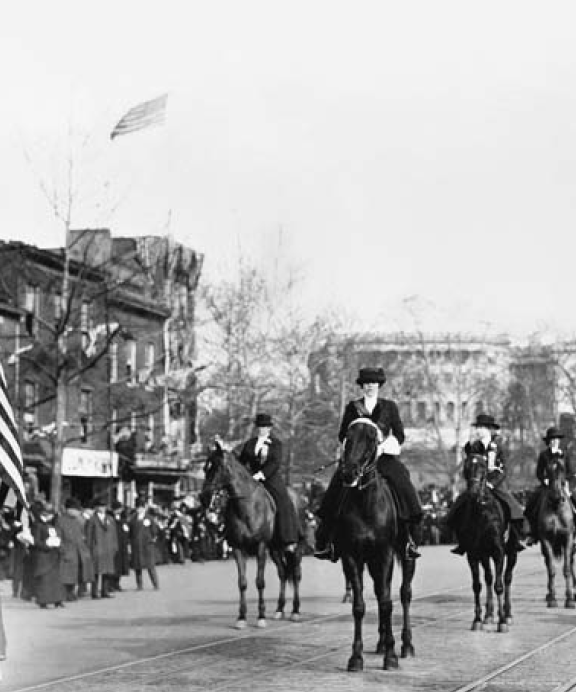 Women suffragists at the head of the parade, marching down Pennsylvania Avenue, with the U.S. Capitol in background, on March 3, 1913.  Author Unknown, [Public Domain] via Library Congress.