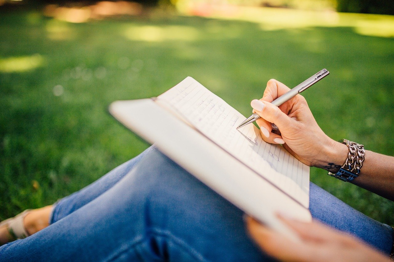 Female writing in a journal