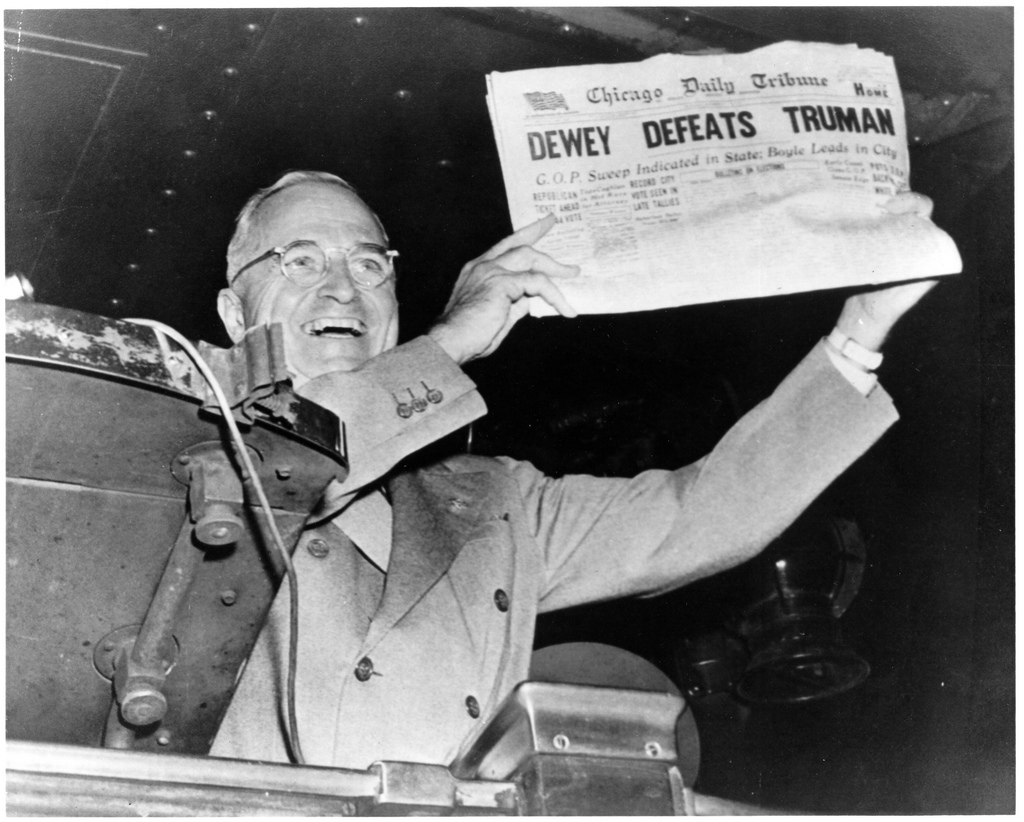 A smiling Truman holds up a Chicago Tribune newspaper with the headline, "DEWEY DEFEATS TRUMAN"
