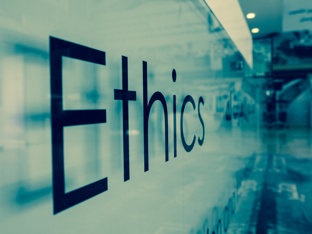 Photo of the word Ethics on a frosted glass wall.