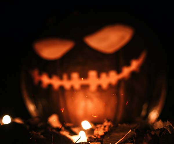 Photo of a pumpkin with a lit up carved face.