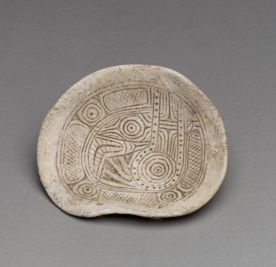 Mississippian shell pendant incised with serpentine design