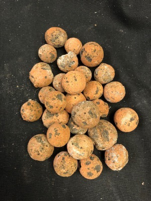 A couple dozen round, brown clay beads