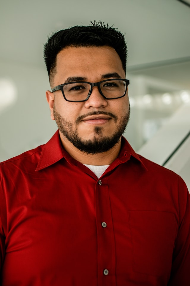 Hispanic man in red shirt smiling