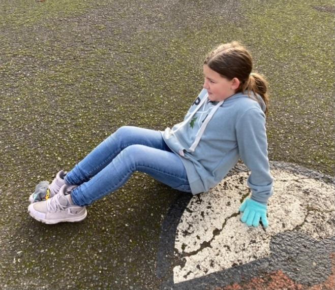 child sitting on pavement