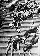 black and white photo of dead civilians strewn down an outdoor wide staircase