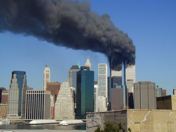 photo of smoke coming out of a tall building