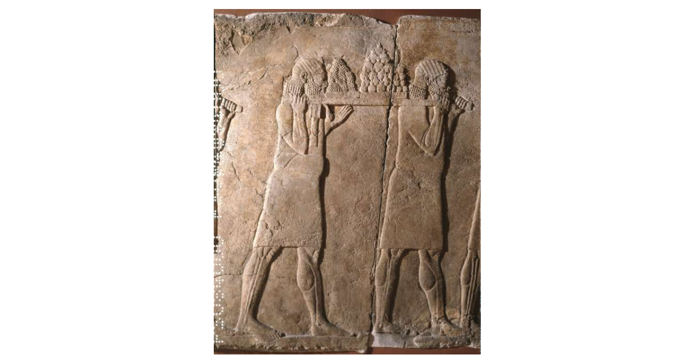 Gypsum wall panel relief; carved, showing men carrying fruit.