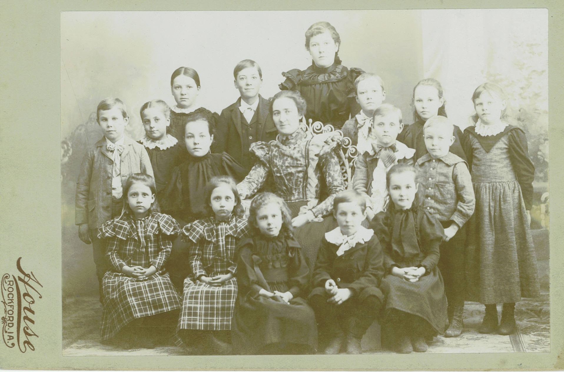 Victorian fashion rural school in Floyd County with students and teacher1880s