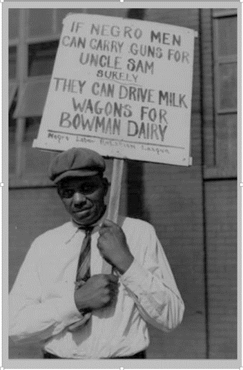 Man carrying sign in front of a milk comant